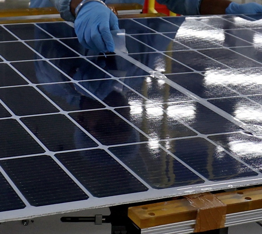 workers assemble photovoltaic modules at the plant of adani green energy ltd (agel), in mundra